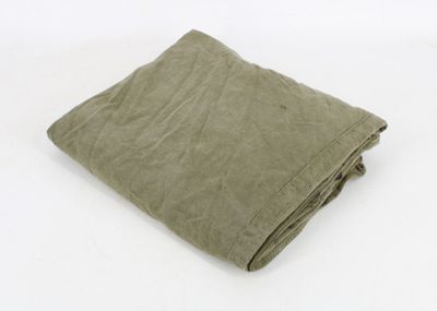 an image of a folded green blanket on a white background