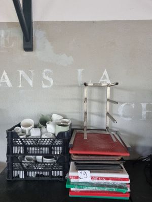 a stack of books sitting on a desk next to a chair