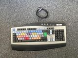 a computer keyboard that is sitting on the floor