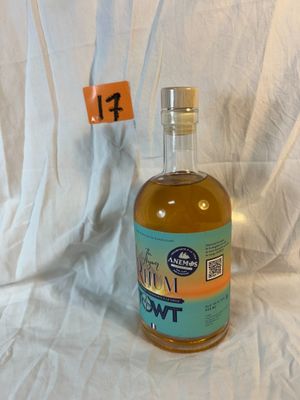 a bottle of liquor sitting on a white cloth