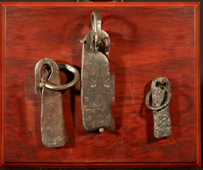three pieces of metal on a wooden surface