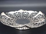 a close up of a silver plate on a black surface