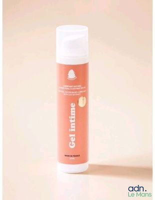 a close up of a bottle of cream on a white surface
