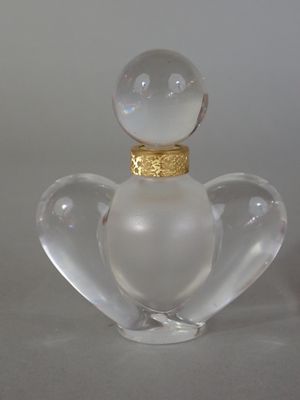 a glass figurine with a gold ring on top of it
