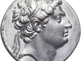 a close up of a silver coin with a woman ' s head on it