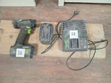 two power tools sitting on a piece of wood on the floor