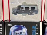 three boxed boxed toys of a bus and a car on a white surface