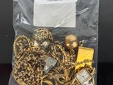 a close up of a bag of gold jewelry on a table