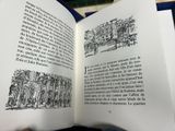 a person holding an open book with a drawing on it