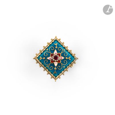 a close up of a blue and gold broochle with a red flower
