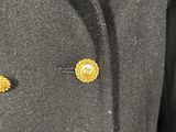 a close up of a coat with two gold buttons on it