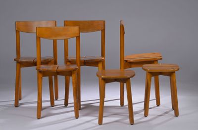 three wooden chairs and a table with a book on top of them