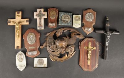 a lot of crosses and plaques on the table
