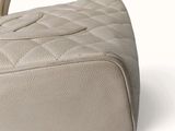 a white purse that is sitting on a white surface