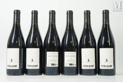 six bottles of wine are lined up in a row on a table