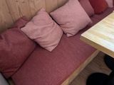a wooden table with a bunch of pillows on top of it