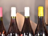 bottles of wine are lined up in a row on a table