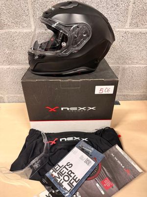 the box is full of items including a helmet, t - shirt, and gloves