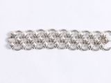 a close up of a silver chain bracelet on a white surface