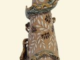 a vase that is sitting on a stand on a white background
