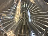 a clear glass vase with a circular design on it