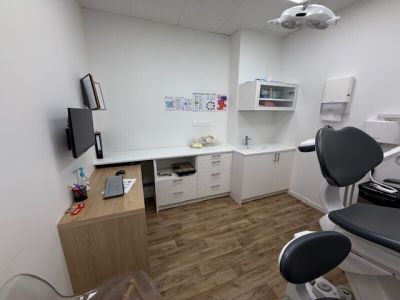 an image of a dentist ' s office with a desk and chair