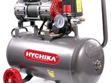 a small air compressor with a gauge on top of it