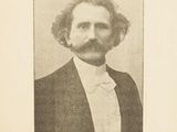 an old black and white photo of a man in a suit and bow tie