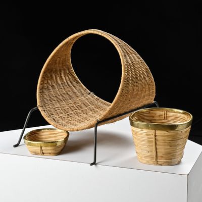 a wicker chair and two baskets on a white pedestal