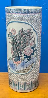 a vase with a picture of a bird on it on a table