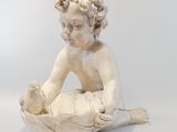 statue of a baby in a bowl on a white background