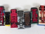 several toy trains are lined up in a row on a white surface