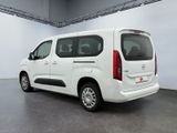 the white van is parked in a large room with a gray floor