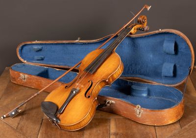 a violin and a violin case sitting on a table