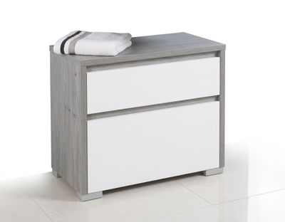 une photo d'une commode blanche et grise sur laquelle sont posées des serviettes