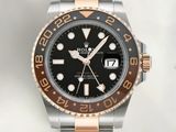rolex watch with a black dial and two tone bracelet