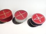 three red and black boxes with a white design on them