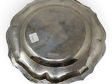 an antique silver plate on a white background with a tag