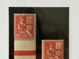 a couple of stamps sitting on top of a piece of paper