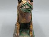 an old bronze figurine of a dog with a mustache on it ' s head