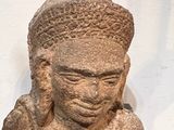statue of a man with a hat on his head sitting on a table