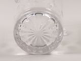 a clear glass pitcher with a star design on it