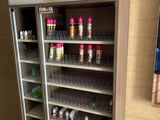 a display case with a variety of drinks inside of it