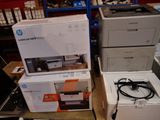 boxes of printer and laptops are stacked on top of each other