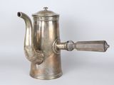 an antique silver coffee pot with a wooden handle on a white background