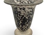a black and white vase sitting on a pedestal