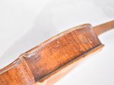 a close up of a violin on a white surface