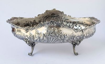 a silver bowl that is sitting on a stand