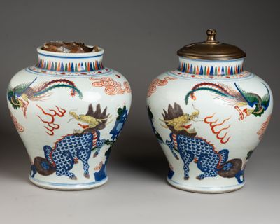 pair of chinese vases with dragon and phoenix designs on them