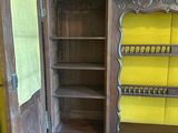 a wooden cabinet with a mirror on top of it
